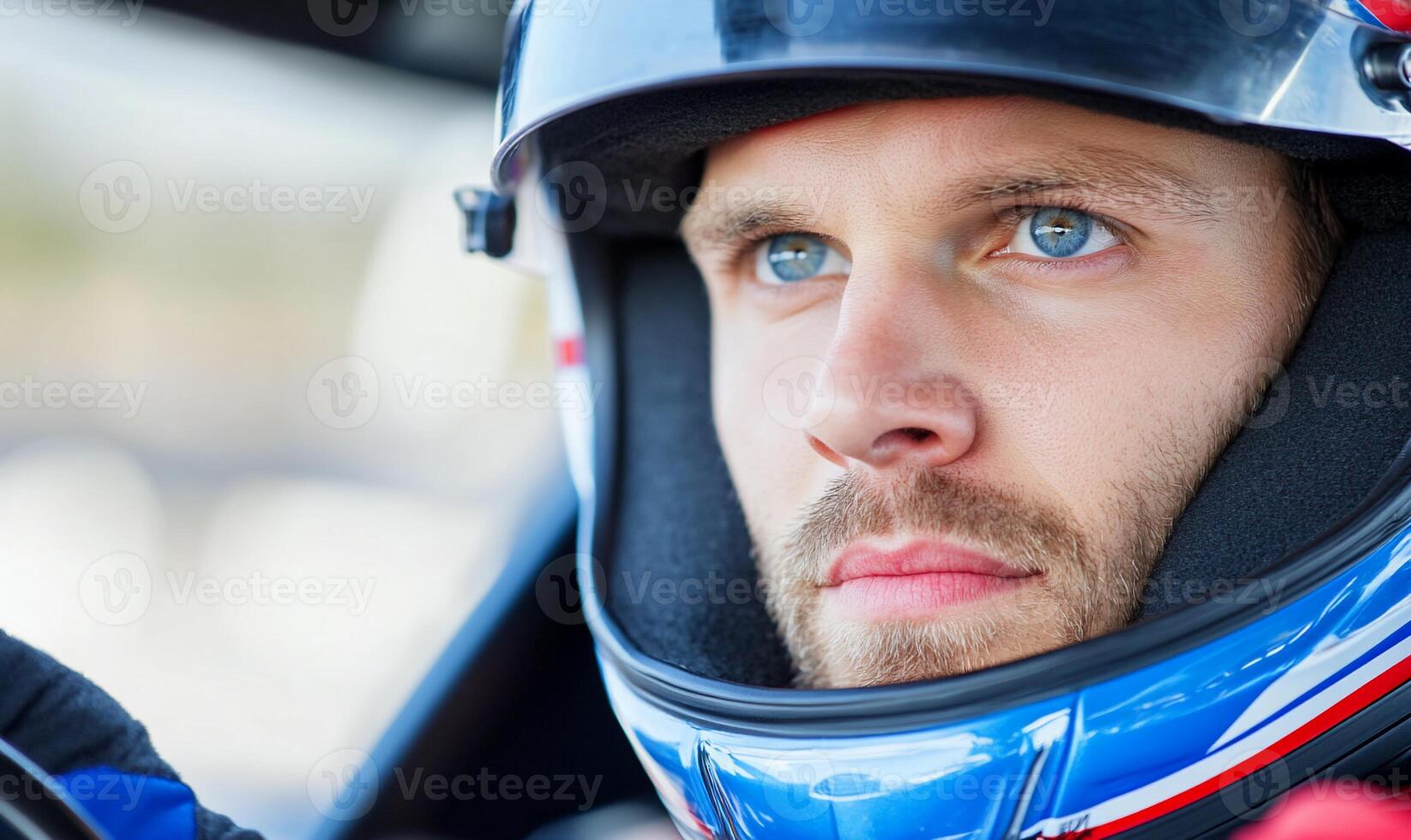A man in a racing car with blue eyes photo