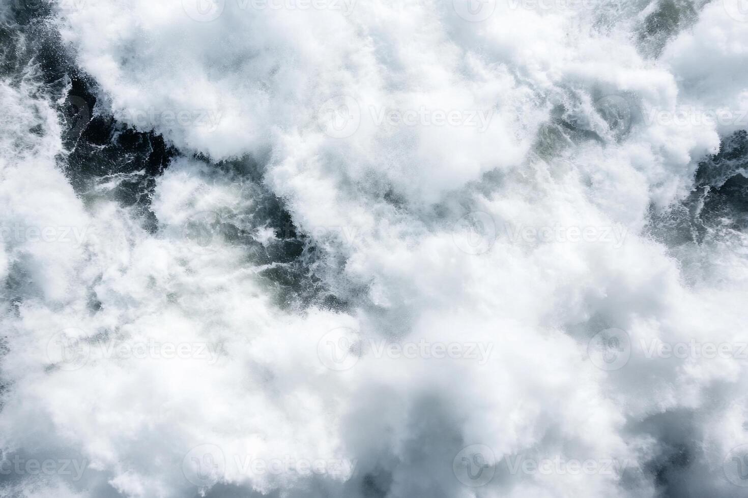 Aerial view of turbulent ocean waves and frothy white surf. photo