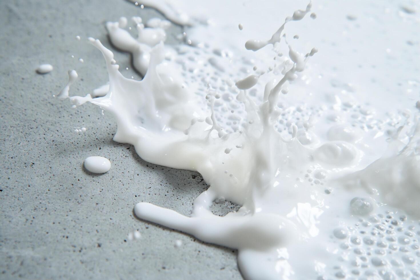 A splash of white liquid on a textured surface, creating dynamic patterns. photo