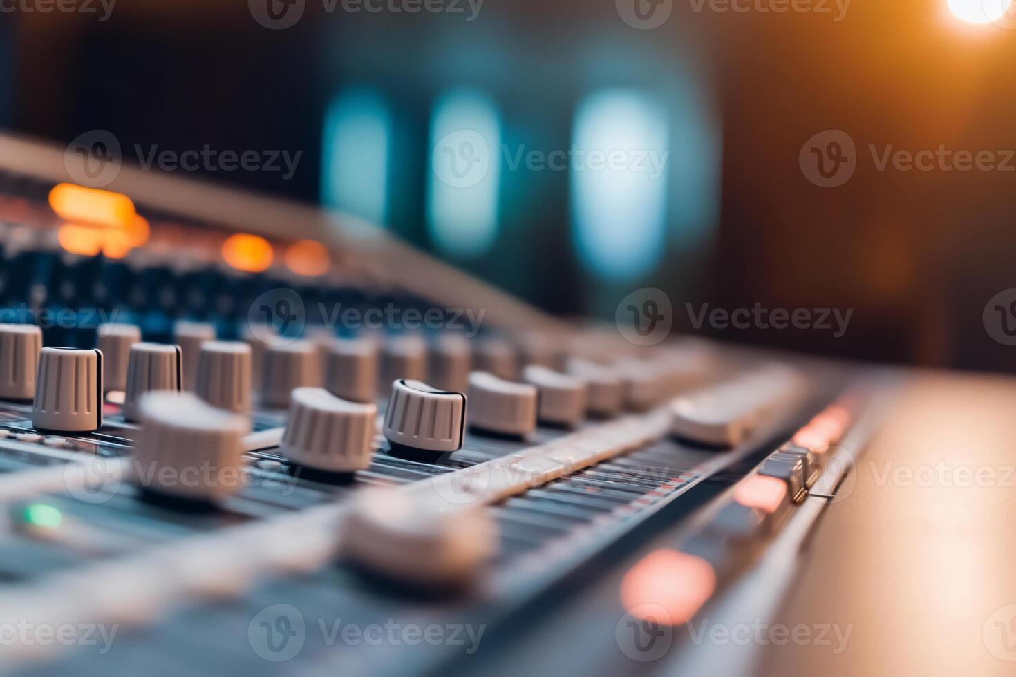Close-up of a sound mixing console with knobs and sliders. photo