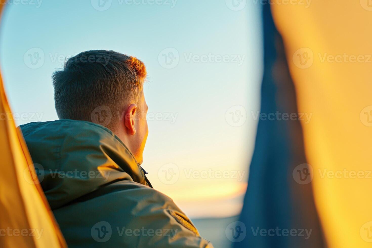 Soldier enjoys warm connection with loved ones during deployment inside tent while calling at sunset photo