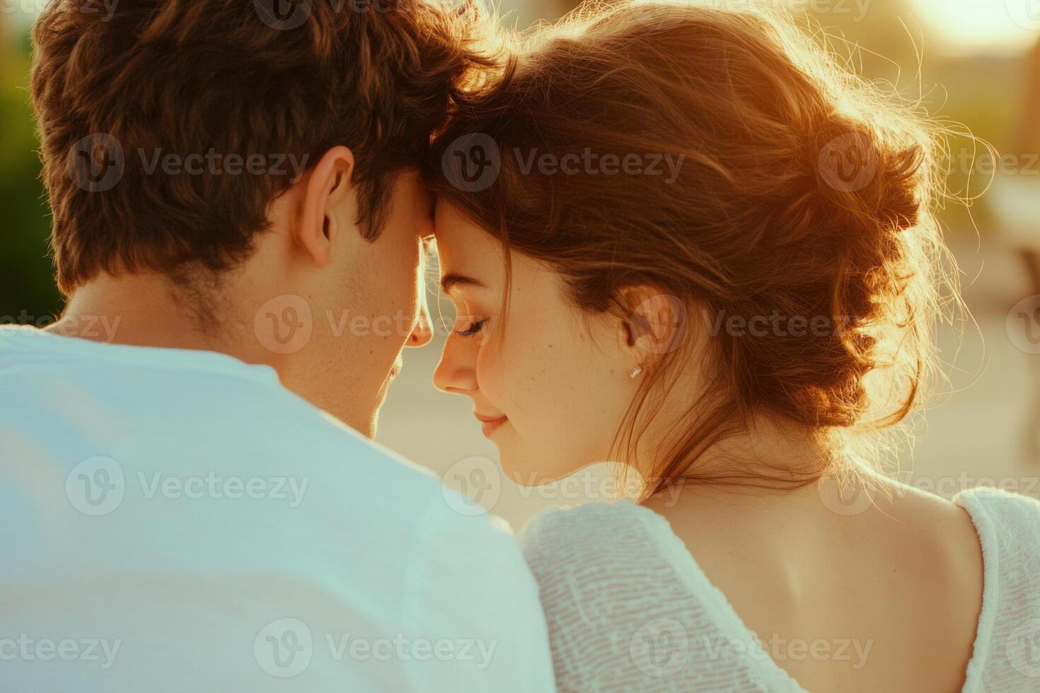 Young couple sharing a whisper on a park bench during a soft morning light, capturing a moment of affection and intimacy photo