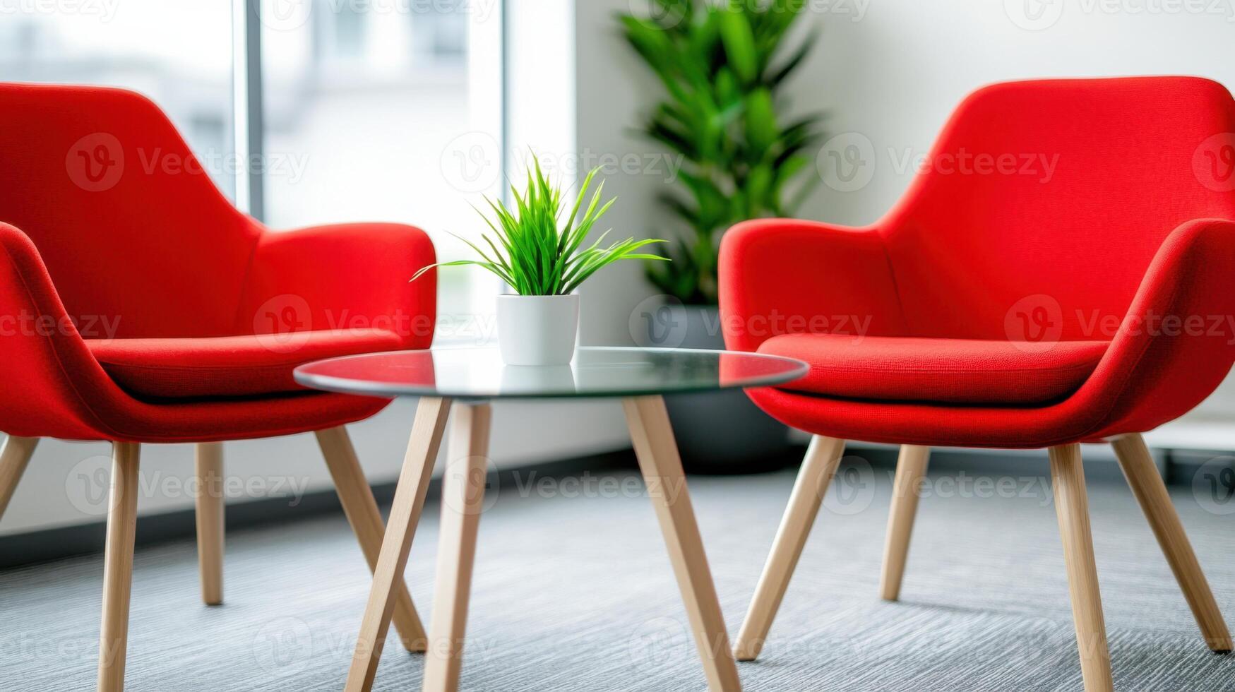 Stylish coworking area with red ergonomic chairs and glass table creating a vibrant workspace environment photo