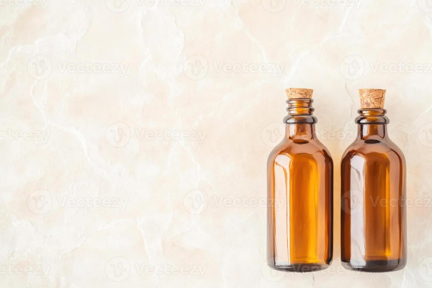Minimalist flat lay showcasing amber glass bottles on natural stone textures with a linen backdrop in warm earthy tones photo