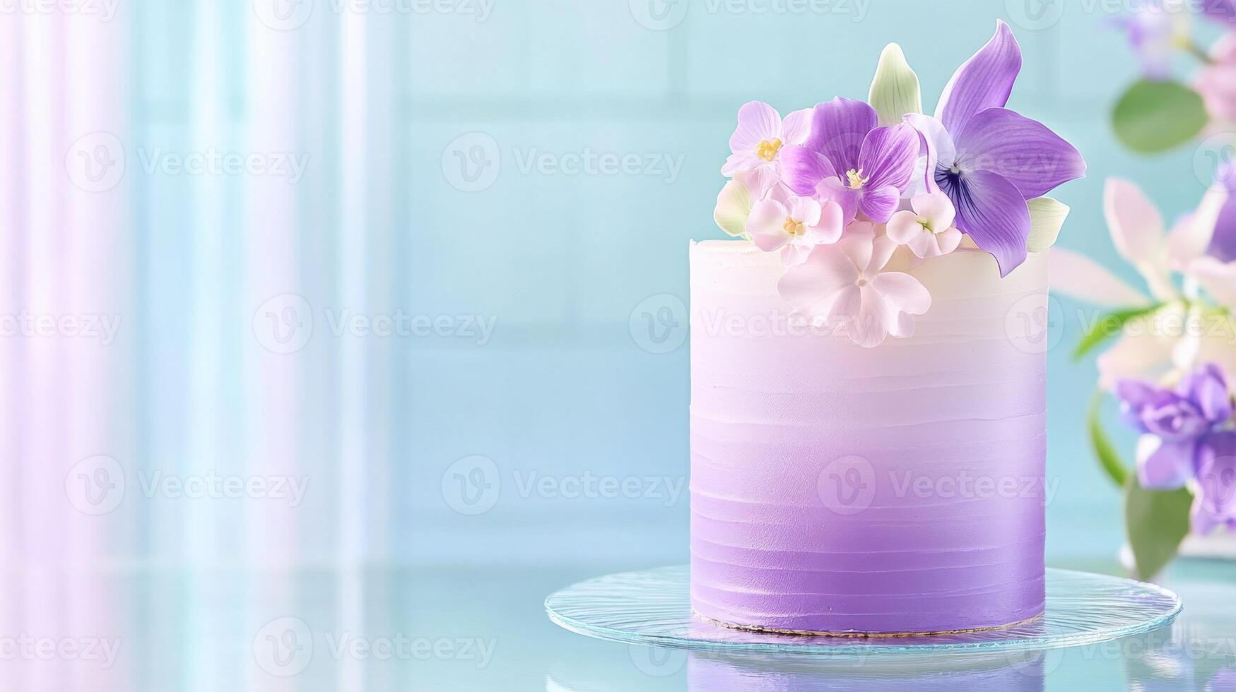 Delicate gradient cake adorned with edible flowers in purple and cyan tones on a modern glass table setting photo