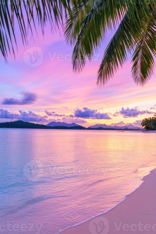Lush tropical beach with crystal-clear cyan waters and a vibrant purple-pink sunset sky framed by palm trees during evening hours photo