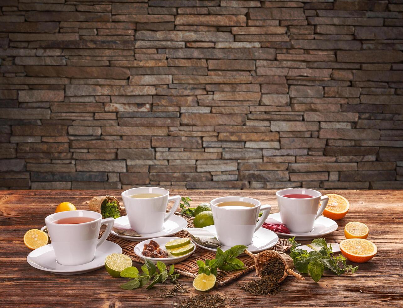 Variety of teas served in white teacups photo