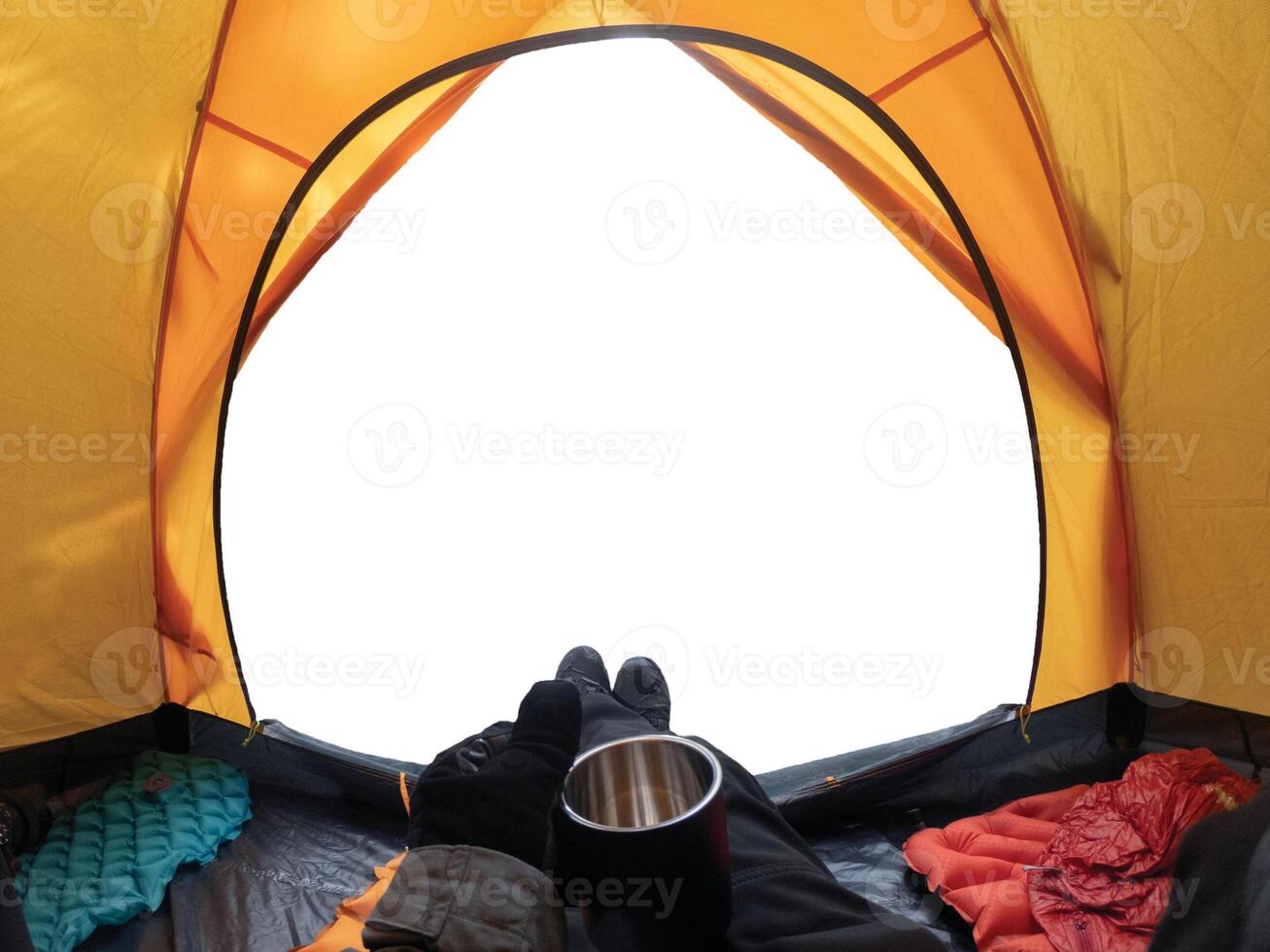 Camping with hand holding cup in yellow tent open on background photo