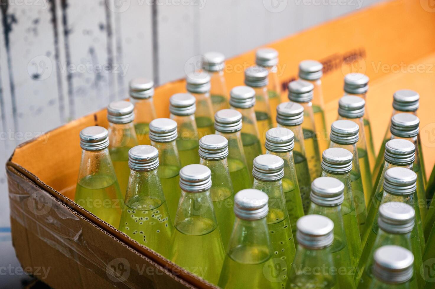 Glass bottled green juice packed in paper box to export at beverage processing factory photo