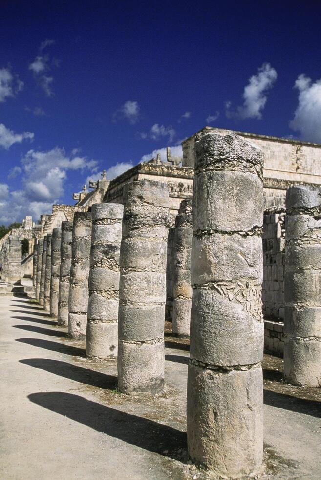 The columns are made of stone and are in a row photo