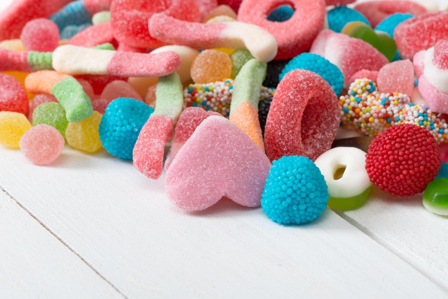 A pile of colorful candy on a white table photo