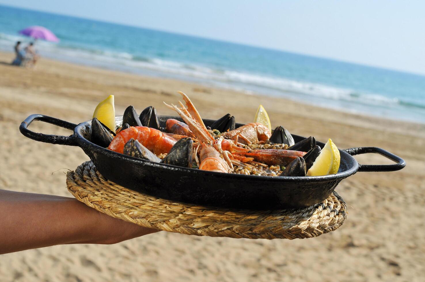 spanish paella on the beach photo