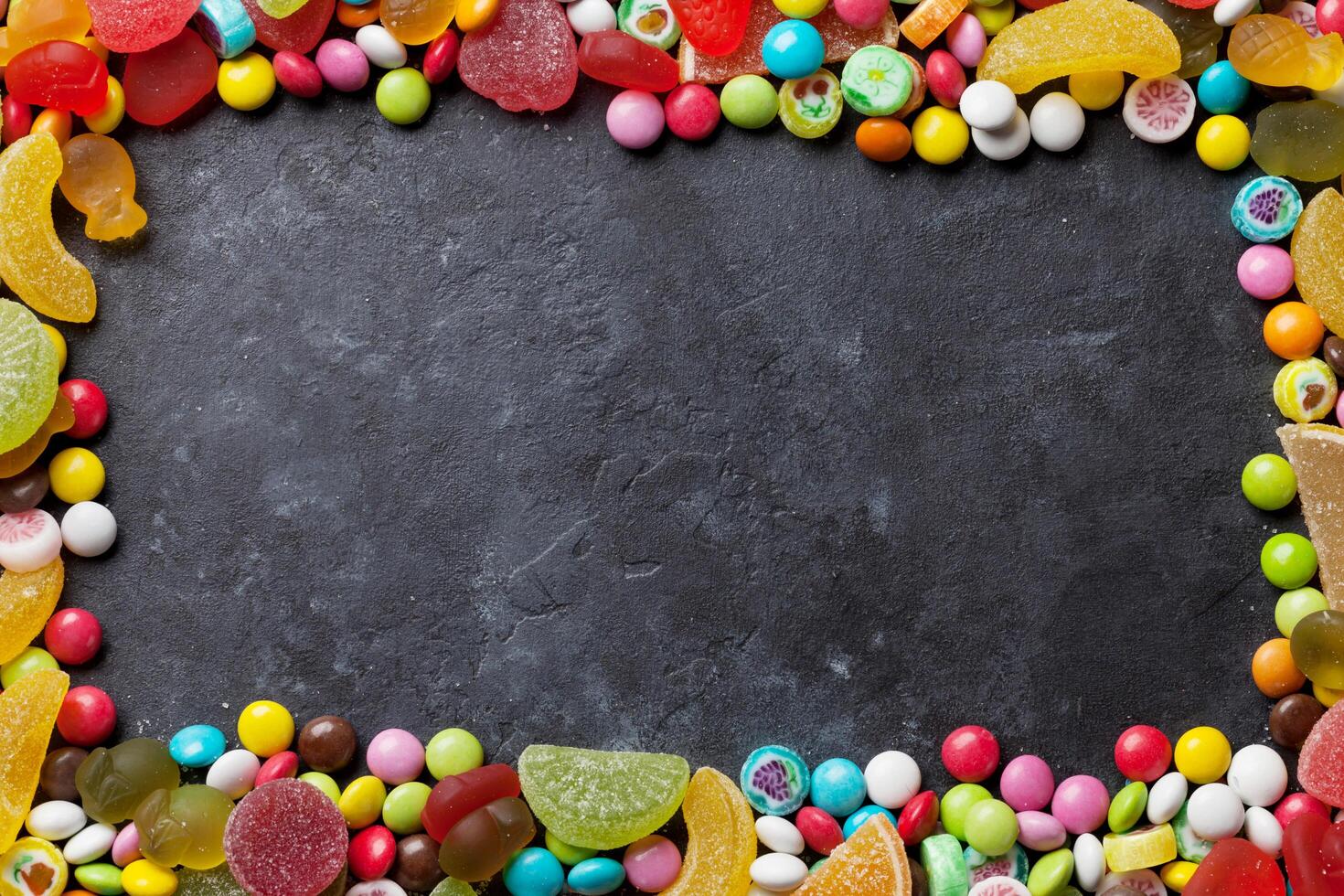 Colorful candies, jelly and marmalade over stone photo