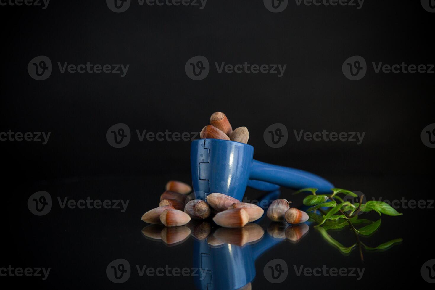 hazelnuts with nutcracker isolated on black background photo