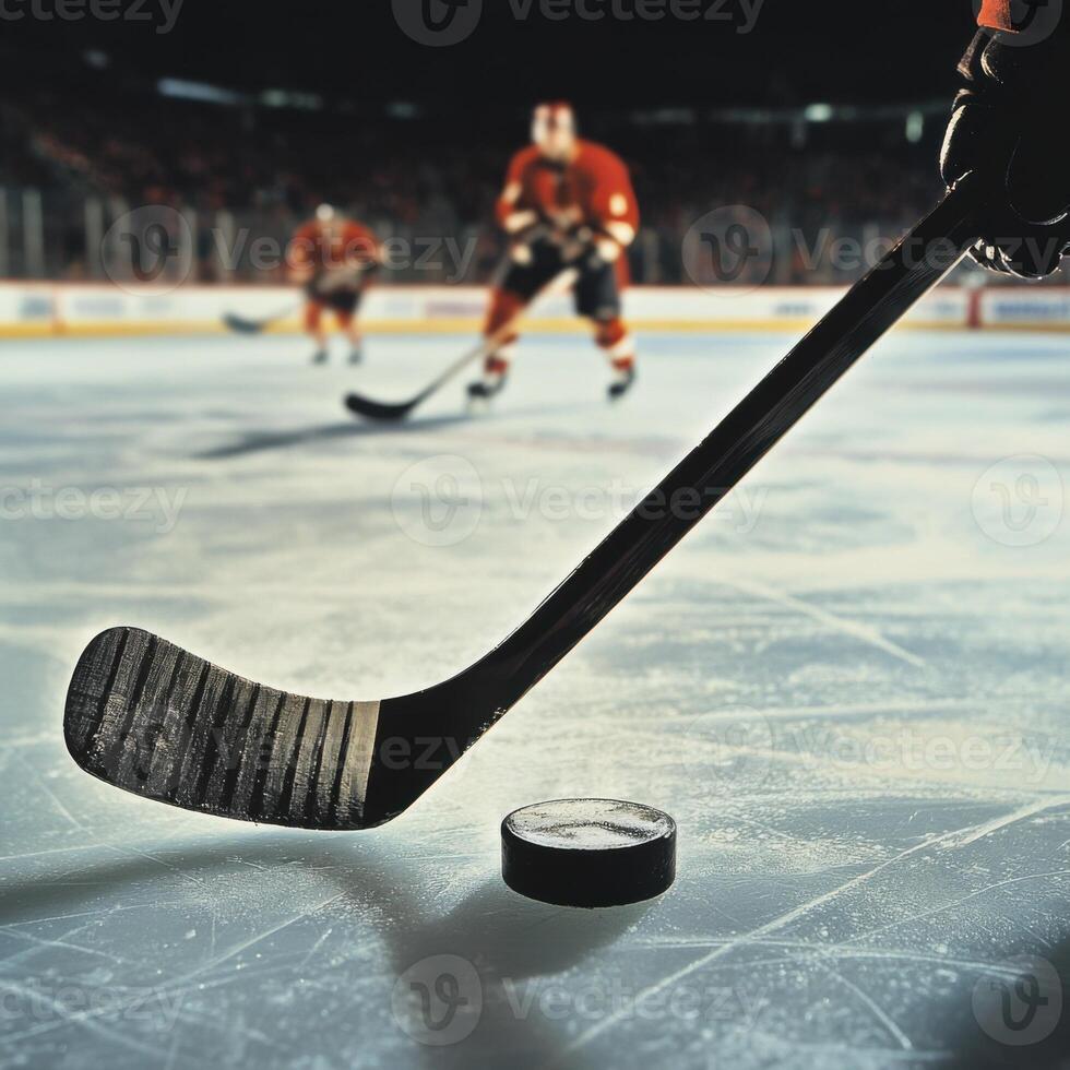 Close-up of hockey stick and puck on ice during a game photo
