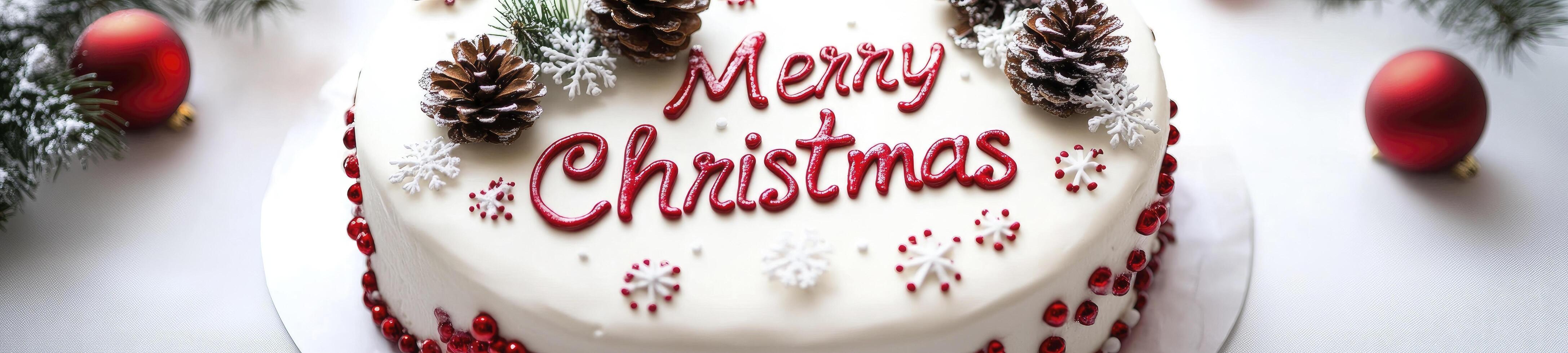 White background, red and white lettering Merry Christmas in the middle of a festive cake decorated with snowflakes and pine cones photo