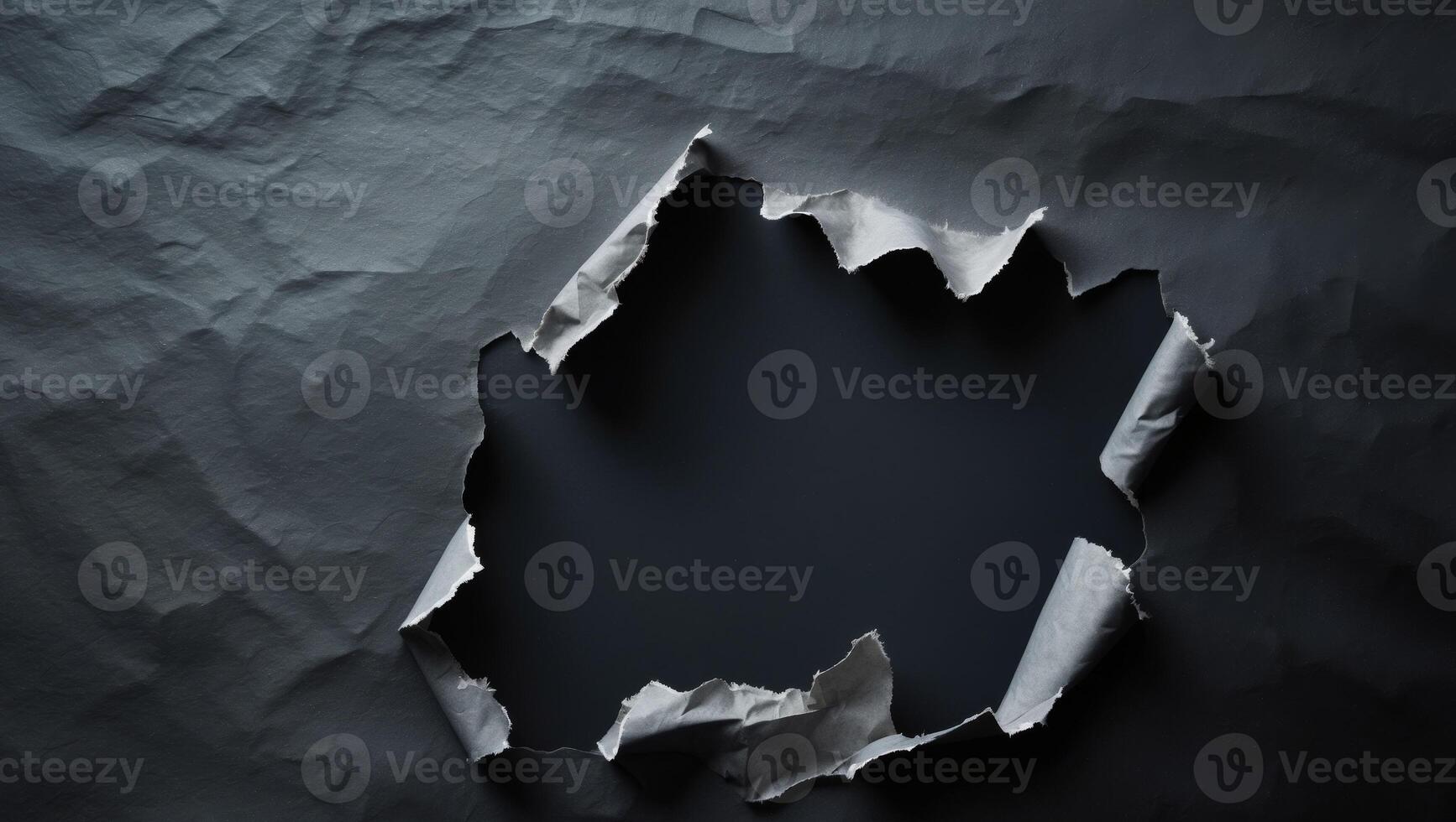 Torn Paper Background with Rip and Hole Effect on Dark Surface photo