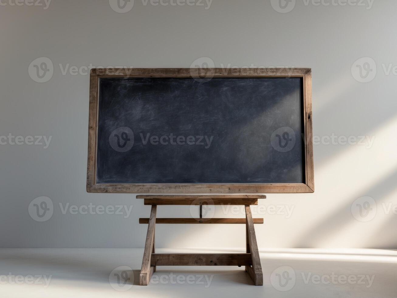 An old blackboard on a wooden stand in front of a window photo