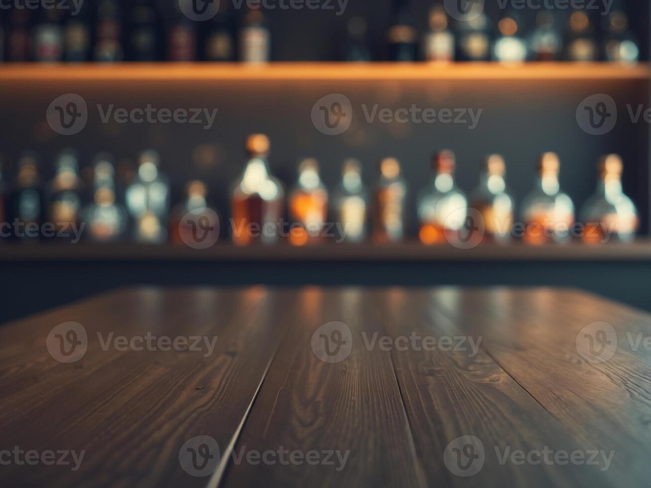 A wooden table in front of a bar with bottles on it photo