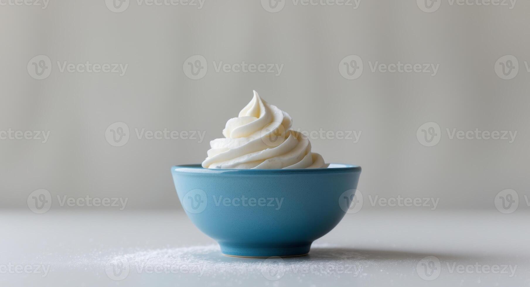 A blue bowl with whipped cream on top photo