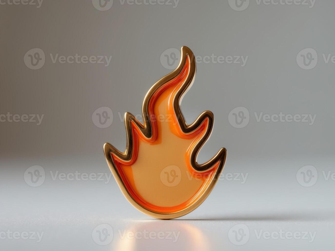 A gold and orange pin that is shaped like a flame photo