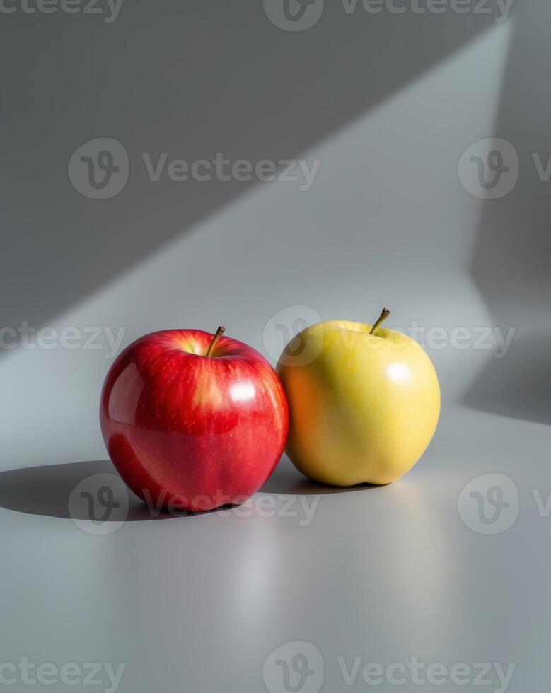 Vibrant Red and Yellow Apples with Glossy Texture on Gray Background. photo