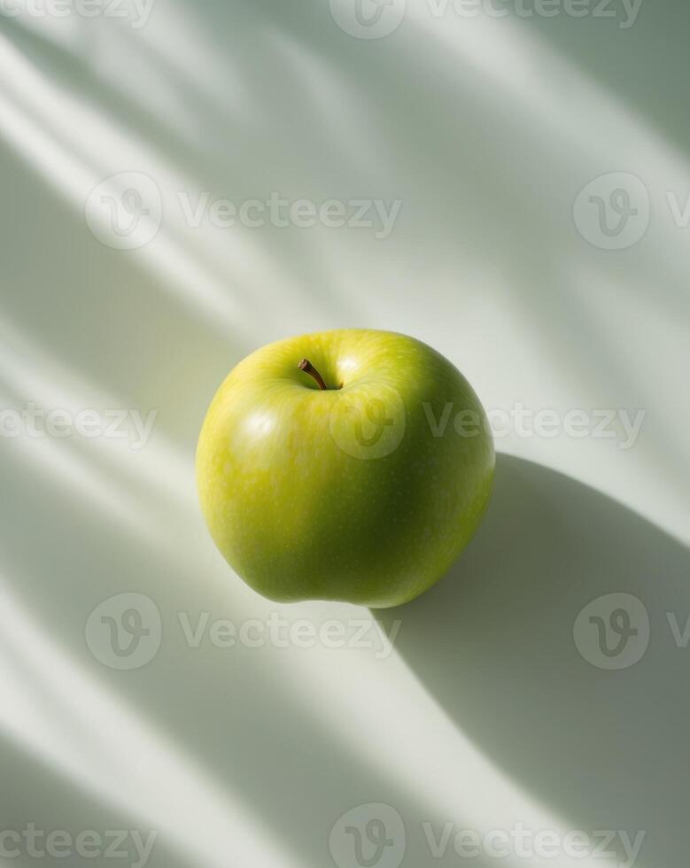 A green apple on a white surface photo