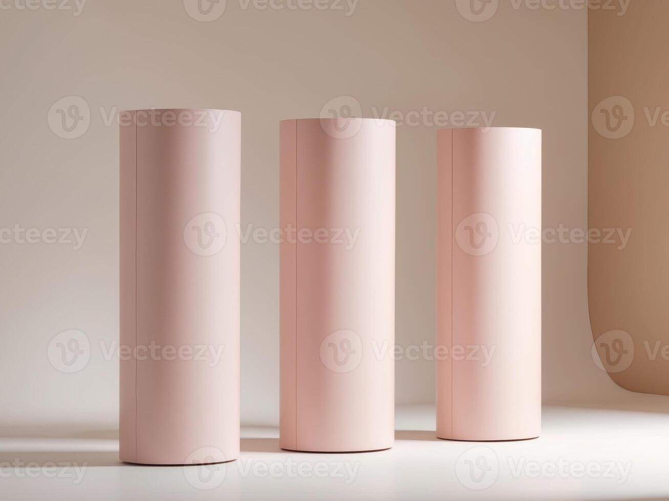 Three pink cylindrical objects sit on a table photo