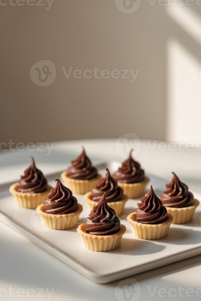 Group of Mini Chocolate Tarts with Chocolate Frosting. photo