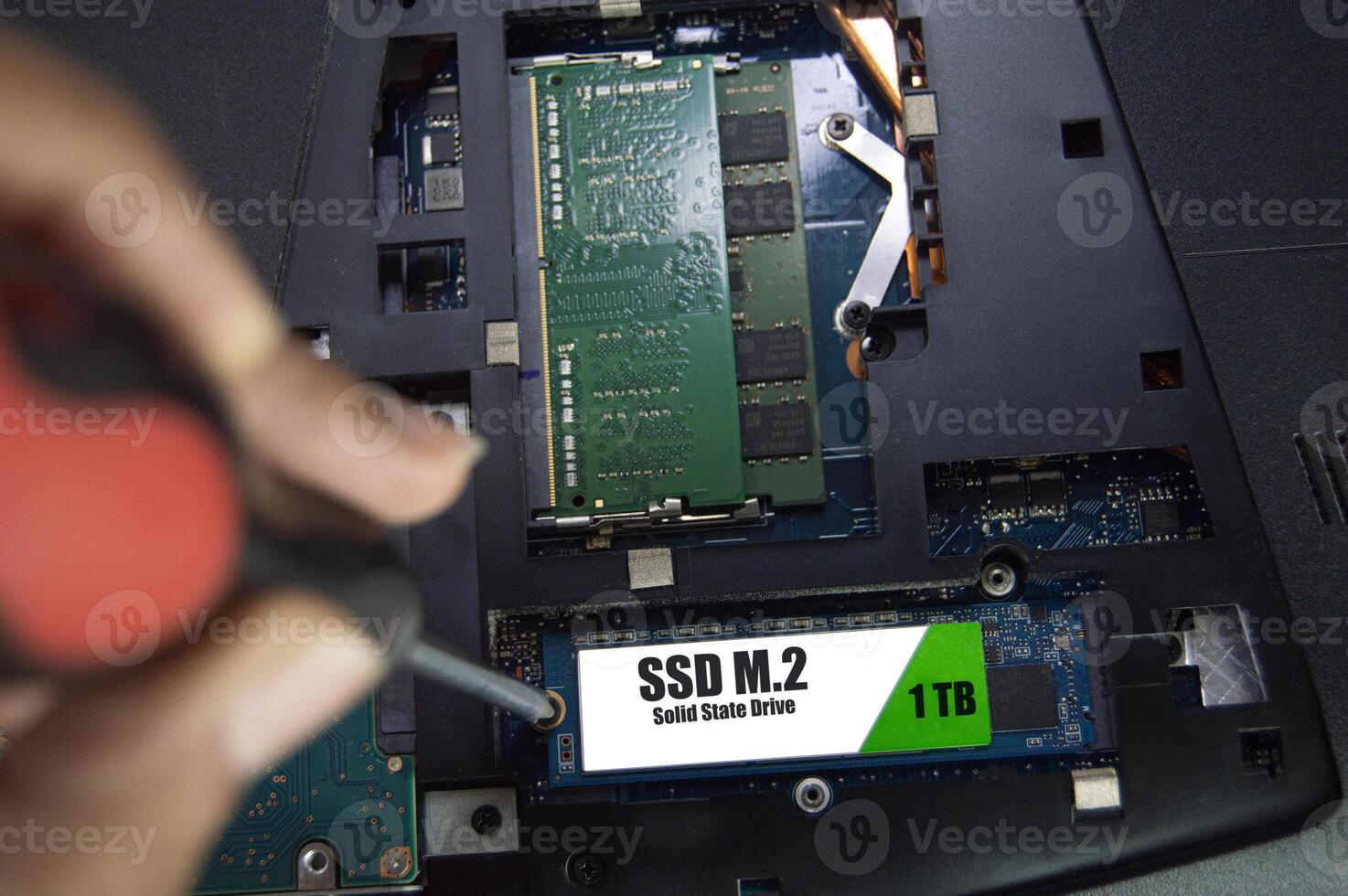 Top view of technician installing M.2 SSD hard drive. photo