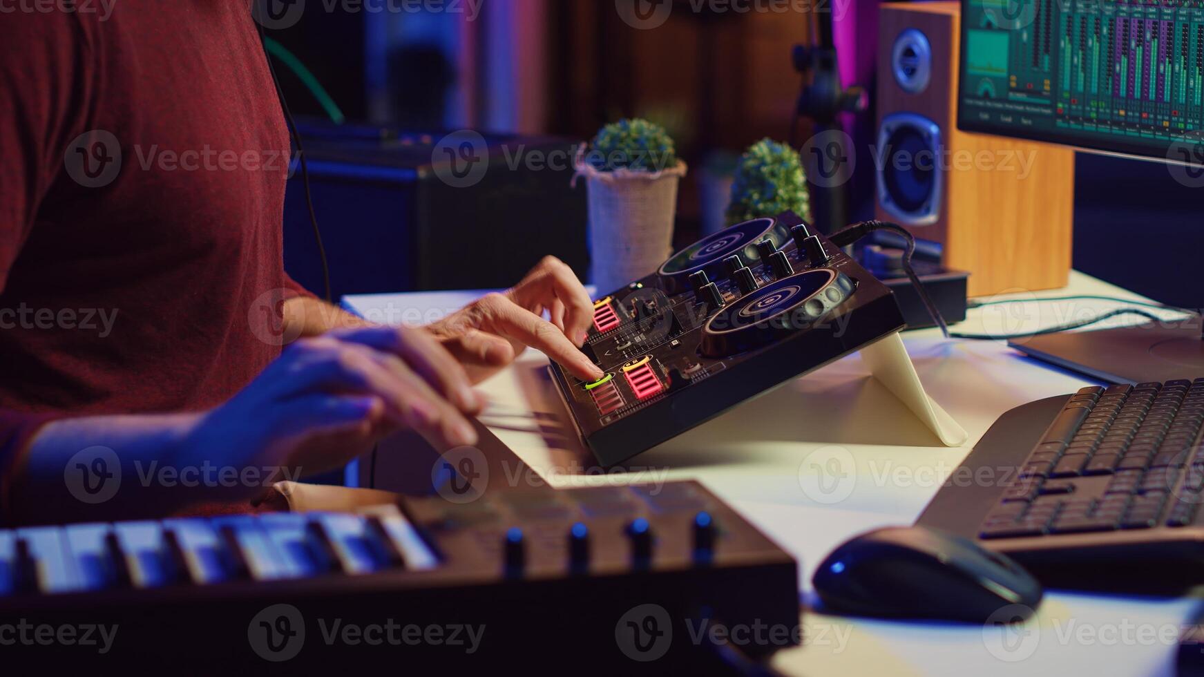 Audio engineer working with soundboard to create the perfect sounds for his new songs, recording and mixing audio. Music producer adjusts volume levels during recording sessions. Camera A. photo