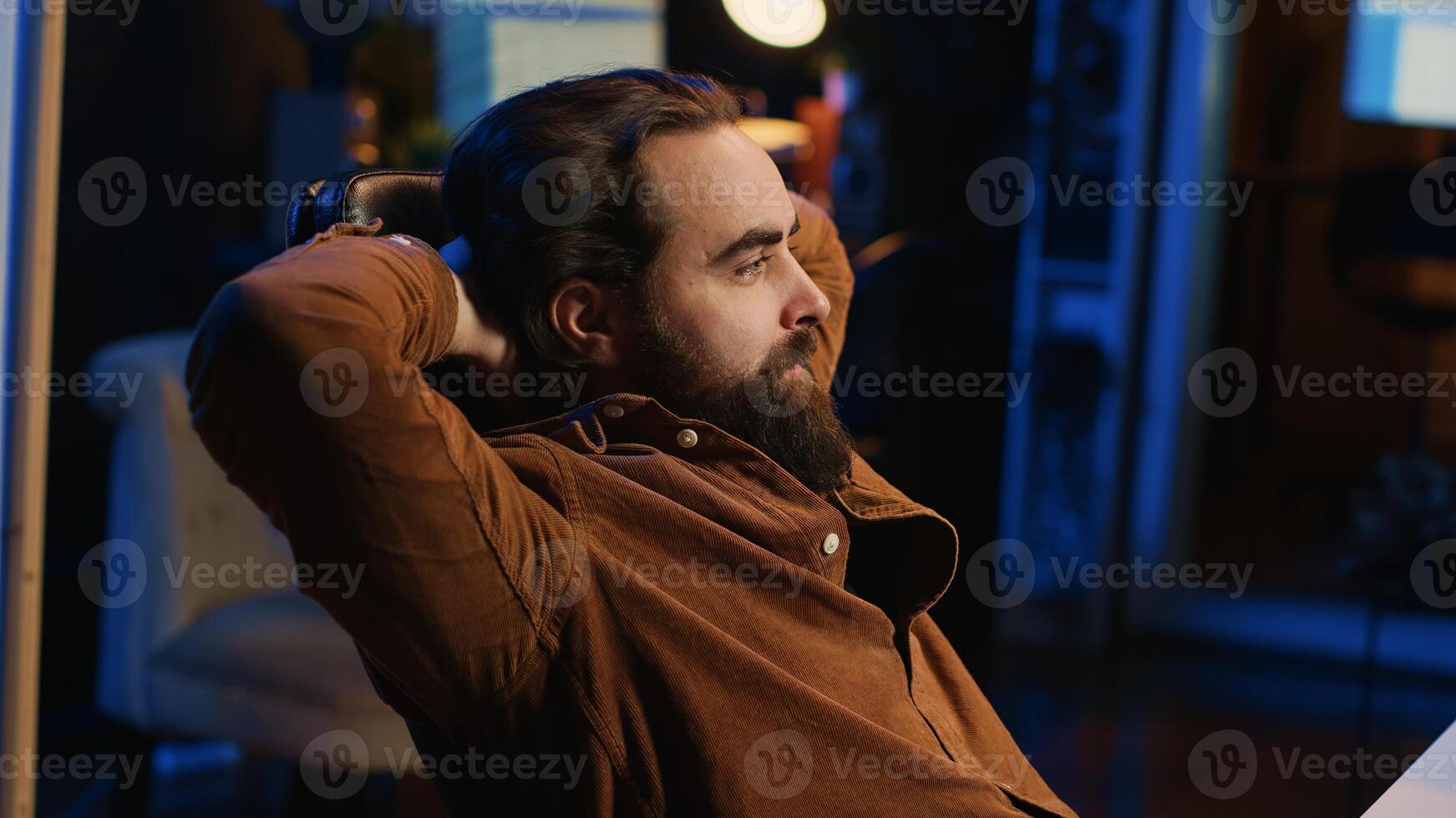 Happy computer scientist feeling relieved, finally being able to relax after removing all code bugs. Joyful IT professional pleased after solving script errors, lounging on desk chair photo