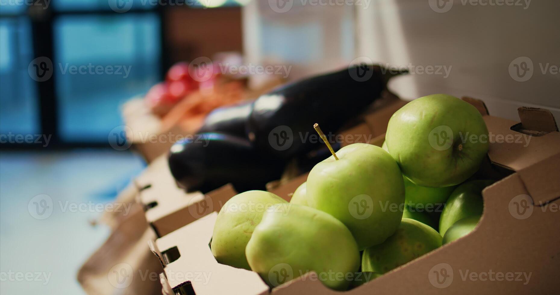 Locally grown ripe fruits and vegetables sold at zero waste shop, nonpolluting ethically sourced produce in crates. Empty supermarket with natural merchandise. Handheld shot. Close up. photo