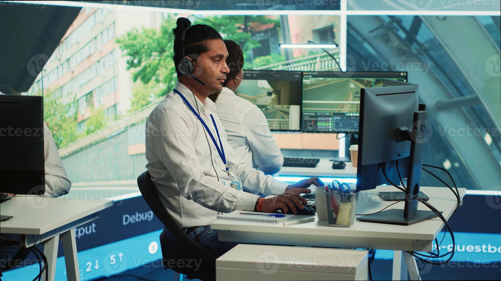 Indian call center operator gathers location and gps coordinates, monitoring traffic via surveillance camera system. Employee using CCTV real time footage to collect data. Camera A. photo