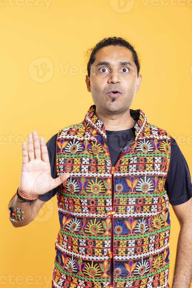 Man trying to stop chaotic fight using calming hand gesture to diffuse tensions, doing peaceful resolution. Reassuring person doing calm down sign gesturing, studio background photo