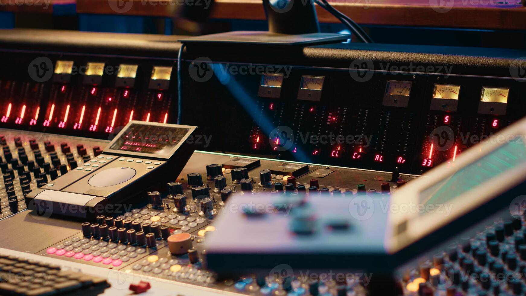 Empty professional studio being equipped with modern technical equipment, control room with sliders, faders and knobs used in mixing and processing sounds. Track recording concept. photo