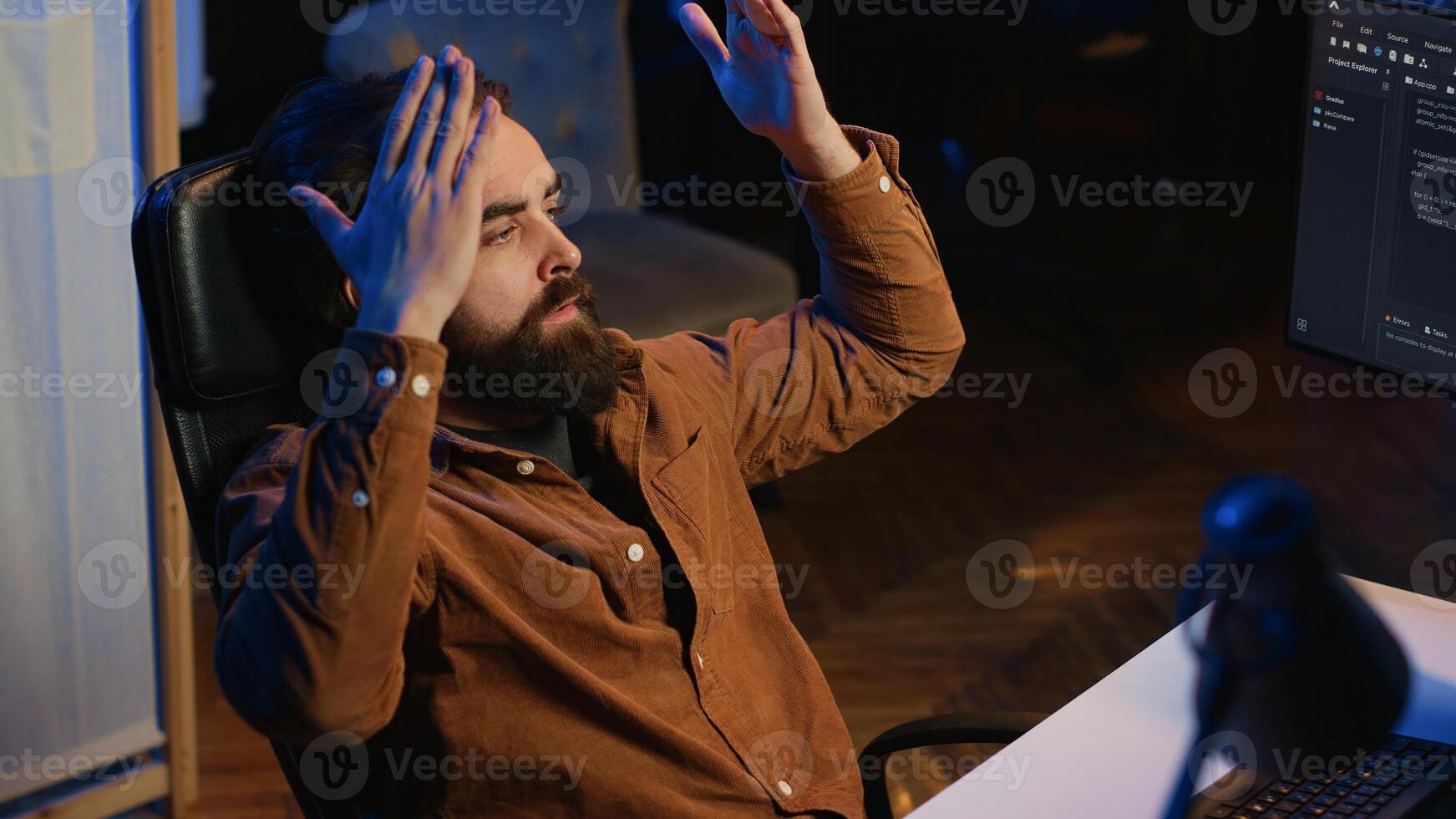 Outraged software engineer perplexed by impossible to remove bugs appearing while coding on computer desktop. Teleworking IT admin feeling baffled by script errors, putting hands on head, camera A photo