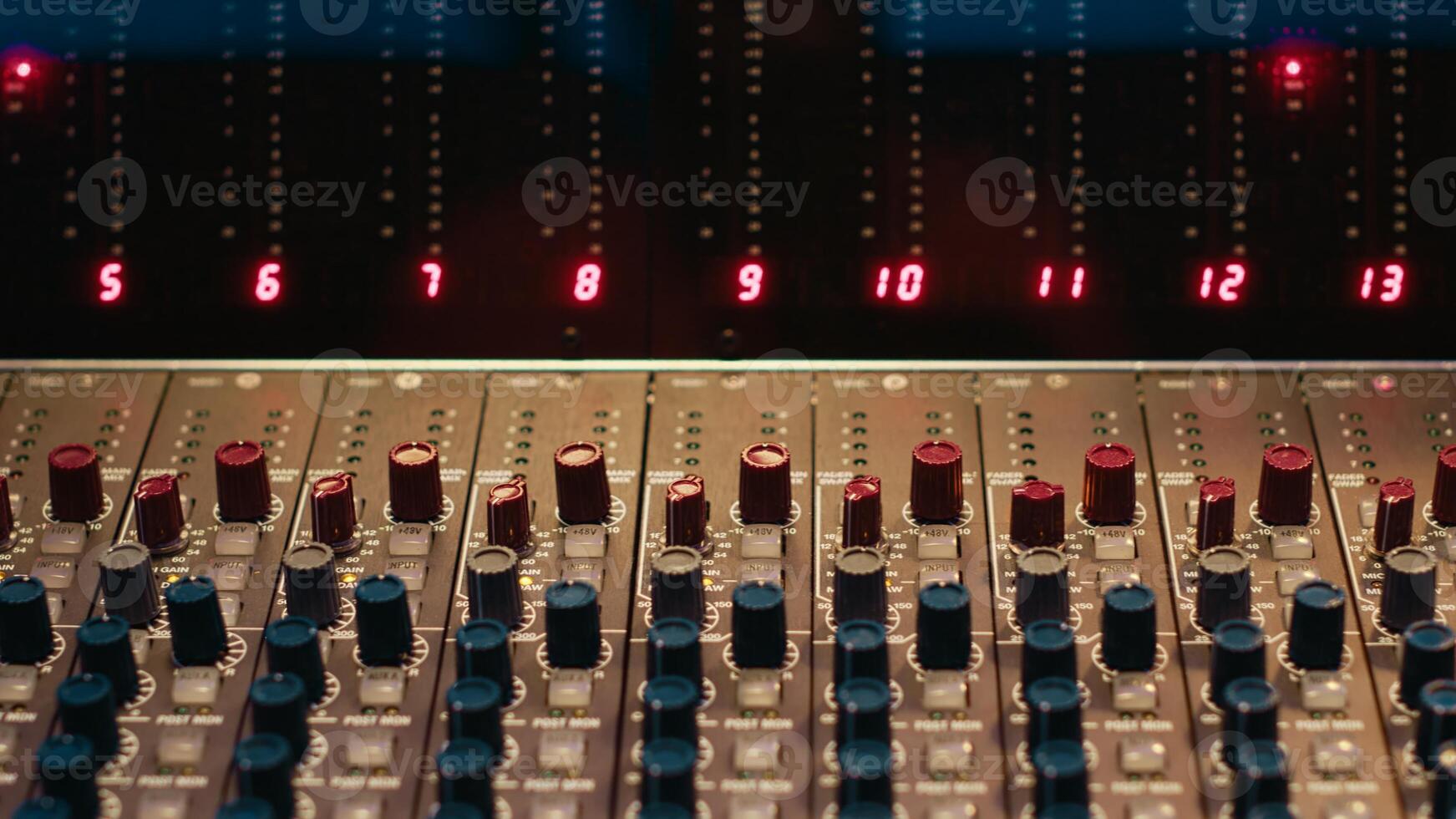 Empty professional studio with control desk mixer and pre amp knobs, music recording and editing with audio software. Control room buttons and sliders in post production, soundproof space. photo