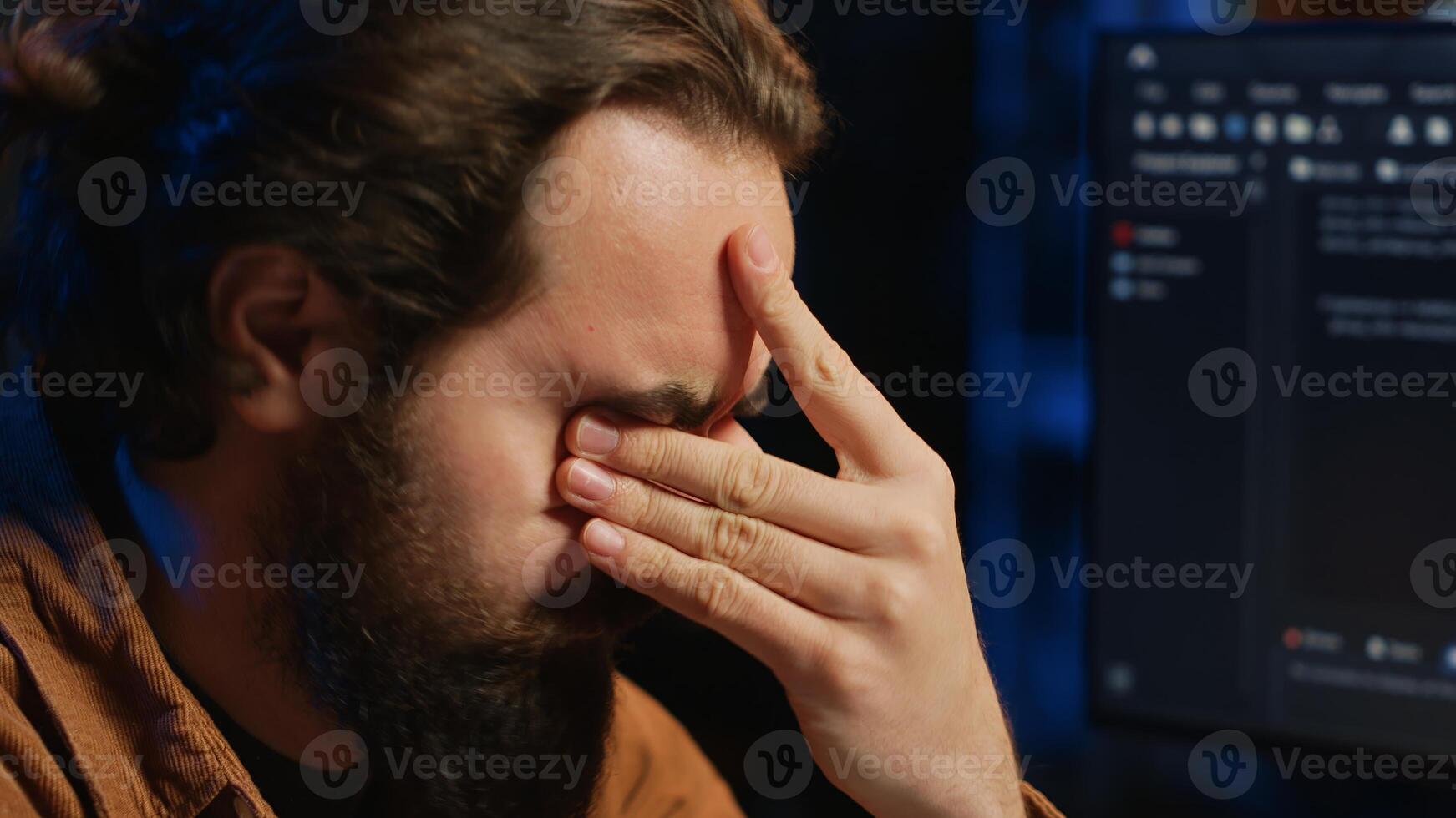 Disappointed computer scientist puzzled after being unable to remove all bugs while coding on workstation desktop. Teleworking IT specialist confused by troubling script errors, camera A close up photo