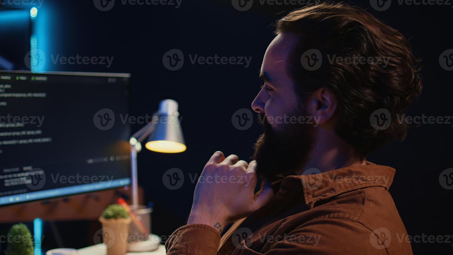 Happy self employed developer in home office doing coding on computer at desk. Joyful IT specialist doing contracted job from apartment, writing lines of code at workstation, camera B close up photo