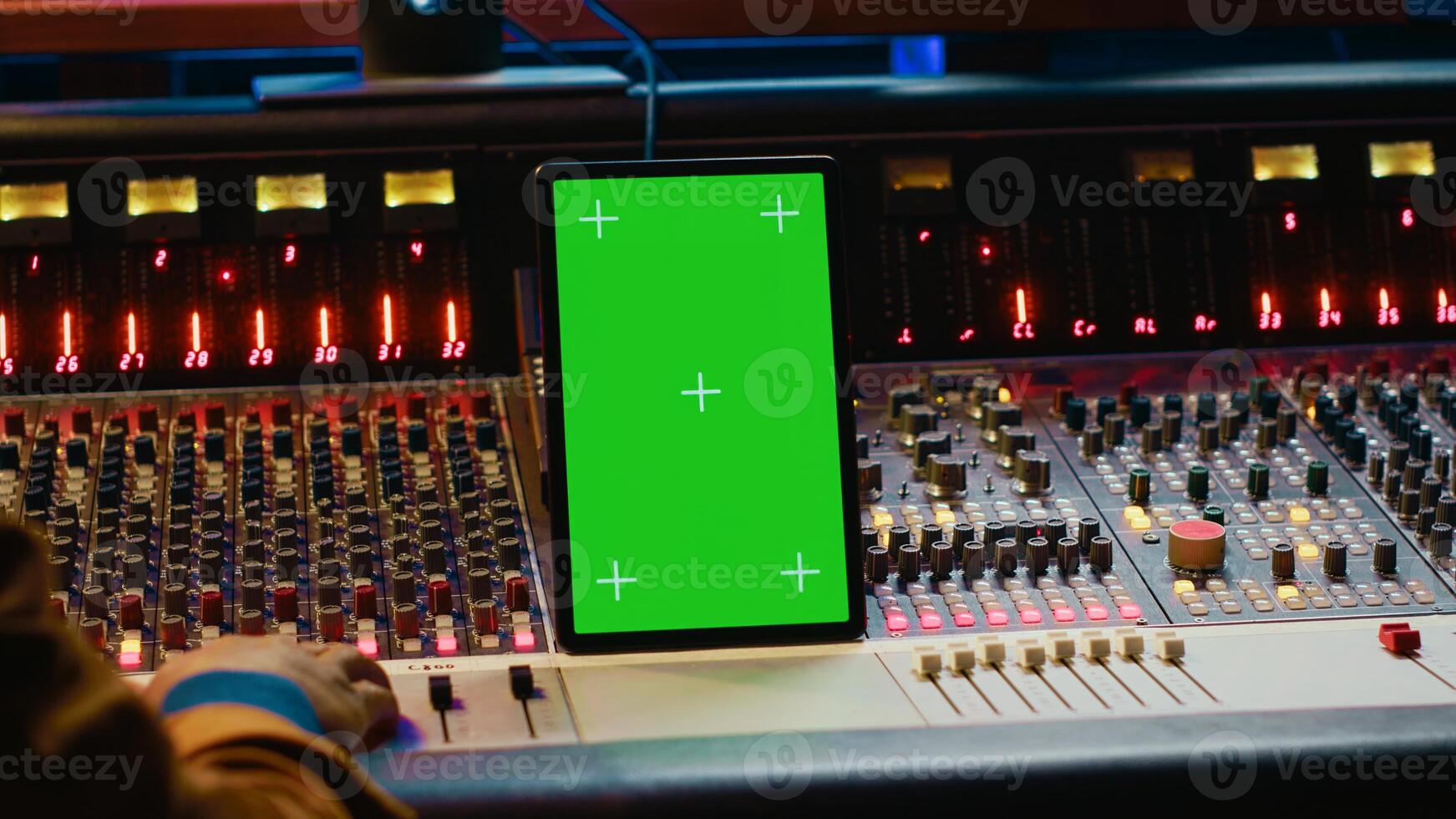 Audio expert processing sounds next to tablet with isolated mockup, working in post production with mixing console and technical gear. Producer pushing switchers and sliders. Camera A. photo