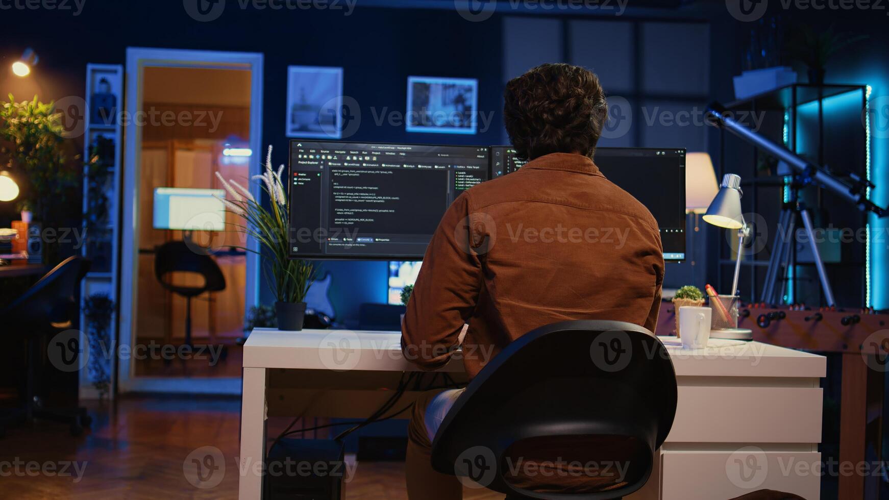 Engineer arriving in home office with mug of coffee in hand, ready to start coding using javascript. IT expert beginning remote work shift, holding cup of tea, updating company software, camera B photo