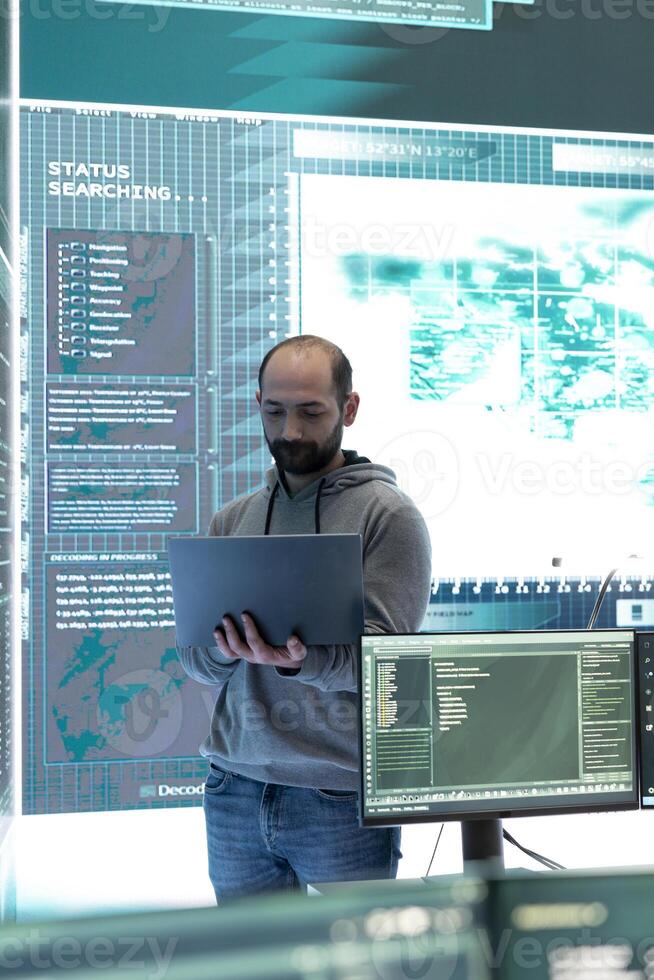 Cyber security team conducting cyber surveillance in a governmental control room. Experts group hacking activities, malware protection and data breach prevention in high tech agency. photo