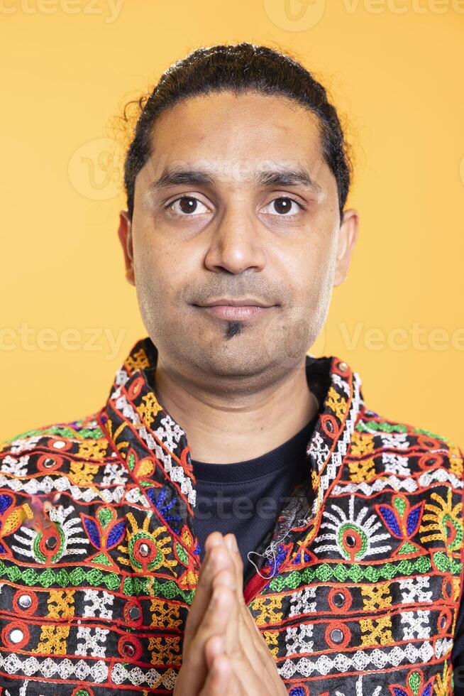 Portrait of anxious man putting hands together, doing gesturing, requesting help, studio backdrop. Close up shot of worried person in need of assistance soliciting aid to solve problem photo