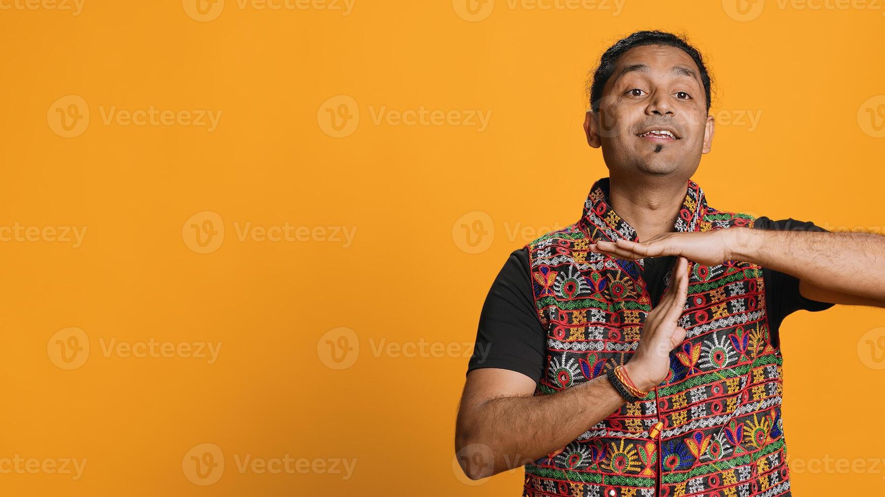 Portrait of assertive indian man asking for timeout, doing hand gestures, feeling fatigued. Firm person doing vehement pause sign gesturing, wishing for break, studio background, camera A photo