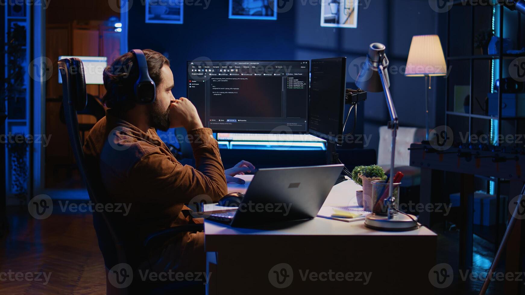 Frenzied programmer suffering from adhd illness, impatiently taping desk with fingers while writing code. Jittery IT expert doing multitasking in office, drinking coffee, listening music, camera B photo