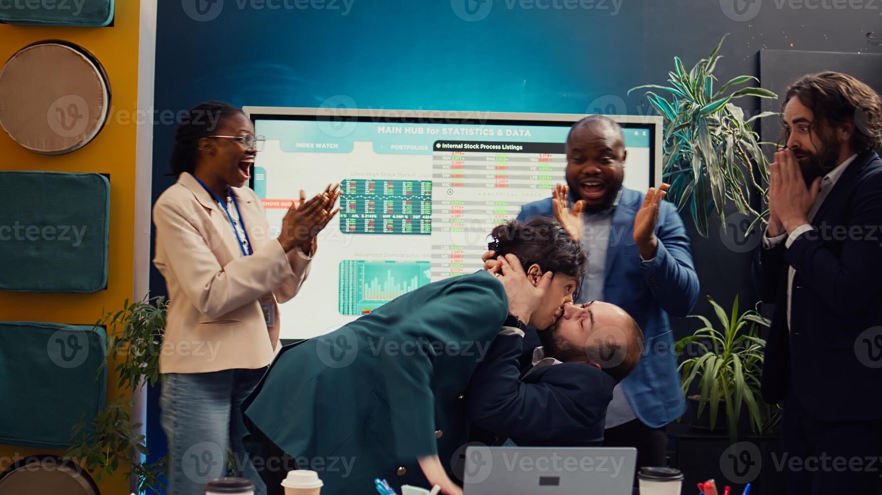 Pleased happy manager celebrating victory and kissing his employee, being in the moment and getting too excited about project success. Supervisor accidentally giving a kiss to his worker. Camera B. photo