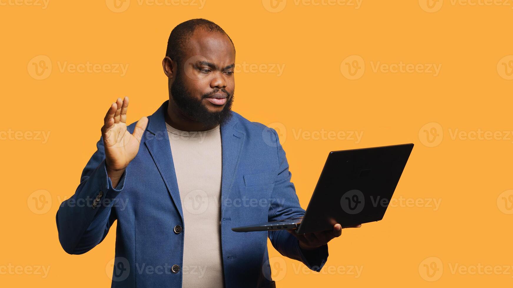 Employee does no hand gesture with finger while chatting with coworker during meeting using laptop, studio background. Person showing disagreeing sign, protesting idea during videocall, camera A photo