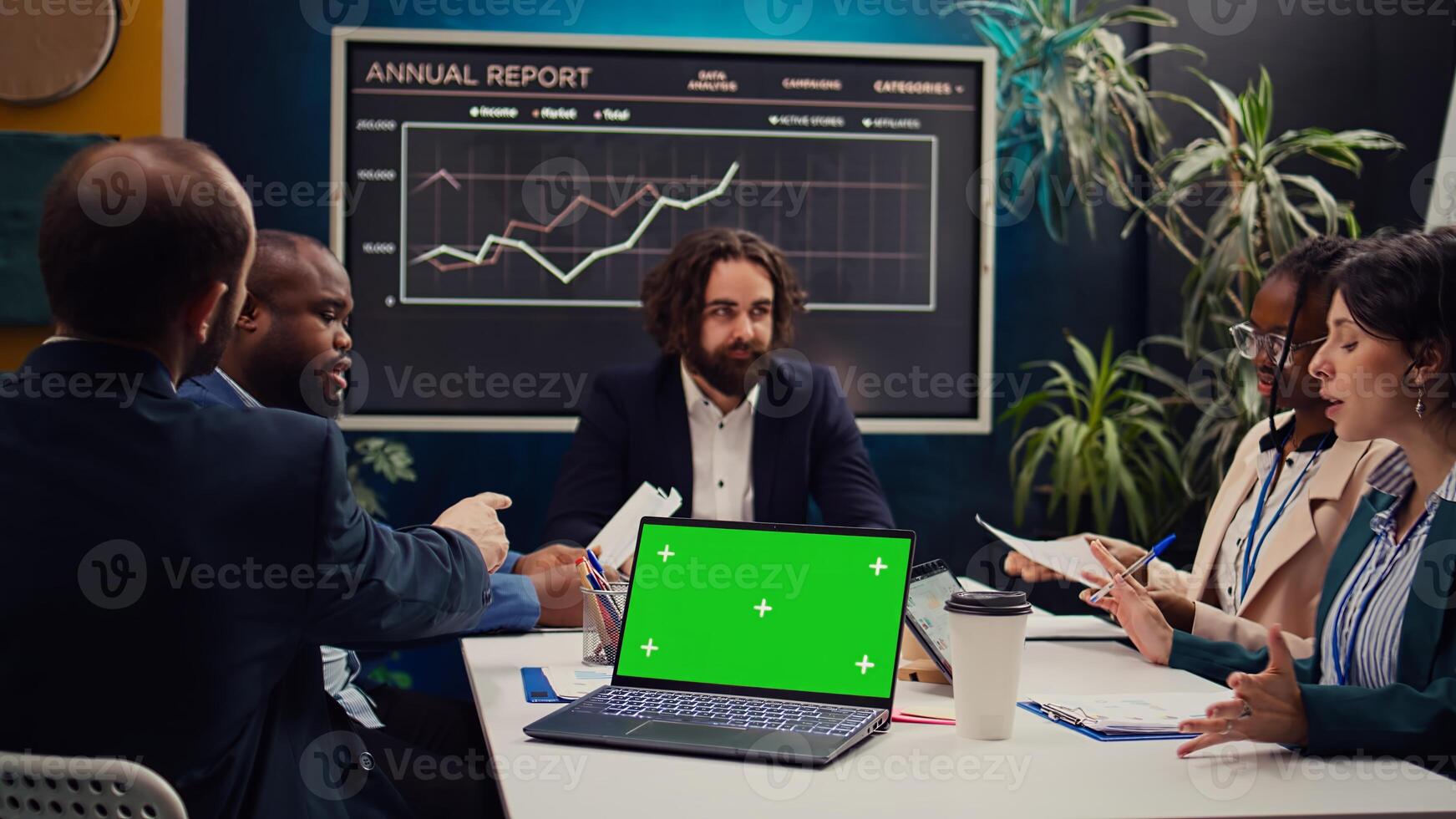 Business partners attending meeting next to greenscreen laptop, discussing the fate of the global enterprise and working on developing financial resources. Startup team address daily issues. Camera B. photo