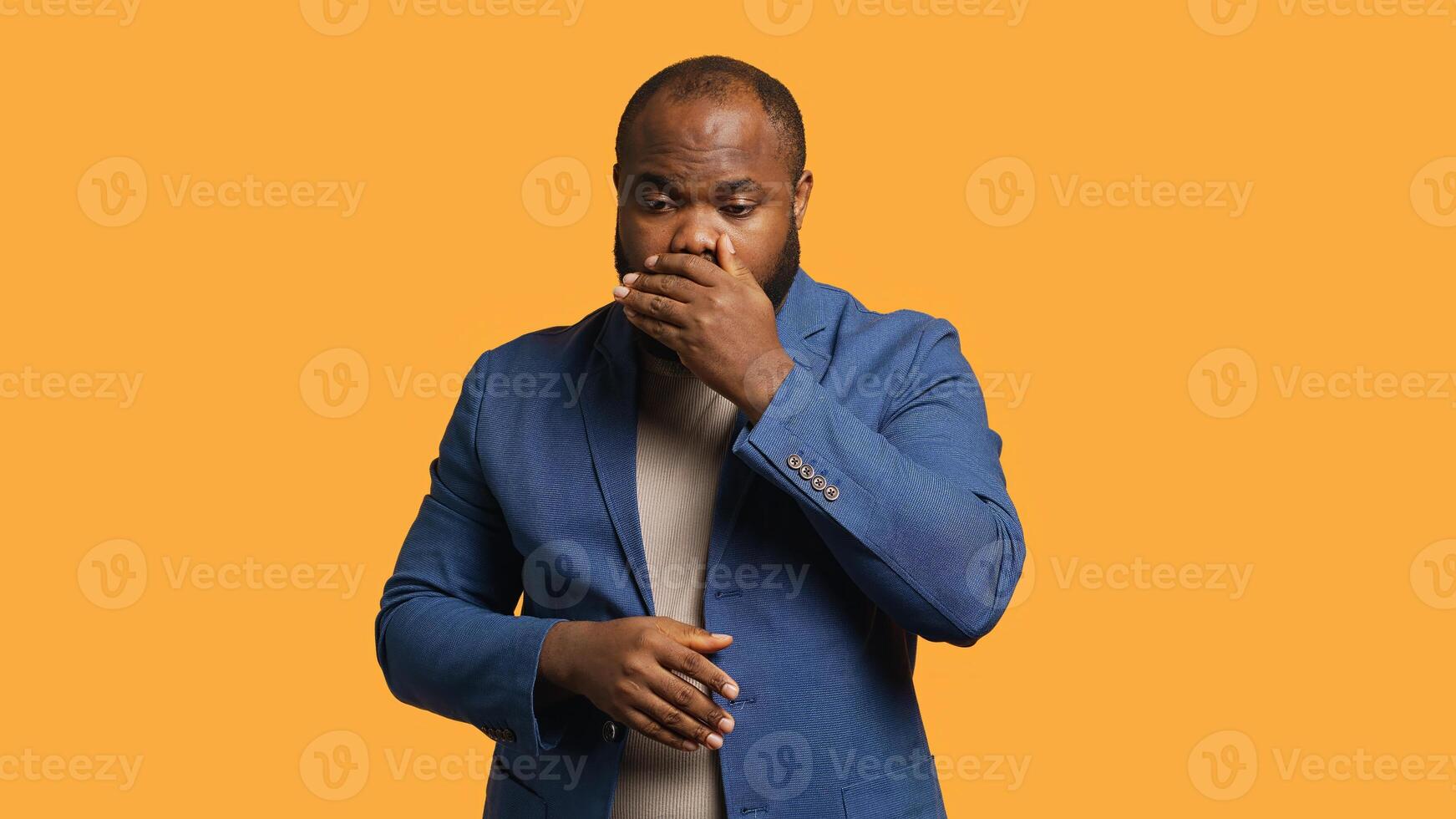 African american man covering mouth in disbelief, feeling upset by events, isolated over studio background. BIPOC person shaking head, left speechless by troubling news, camera A photo